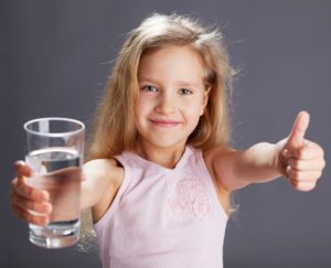Little girl thumbs up - learning and hydration