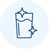 A simple blue line drawing of a glass of water with two sparkle icons, suggesting cleanliness or purity, on a light circular background.